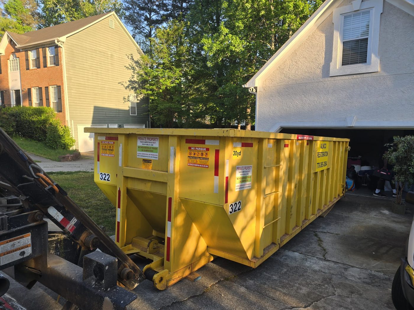 30yd yellow container at residential driveway