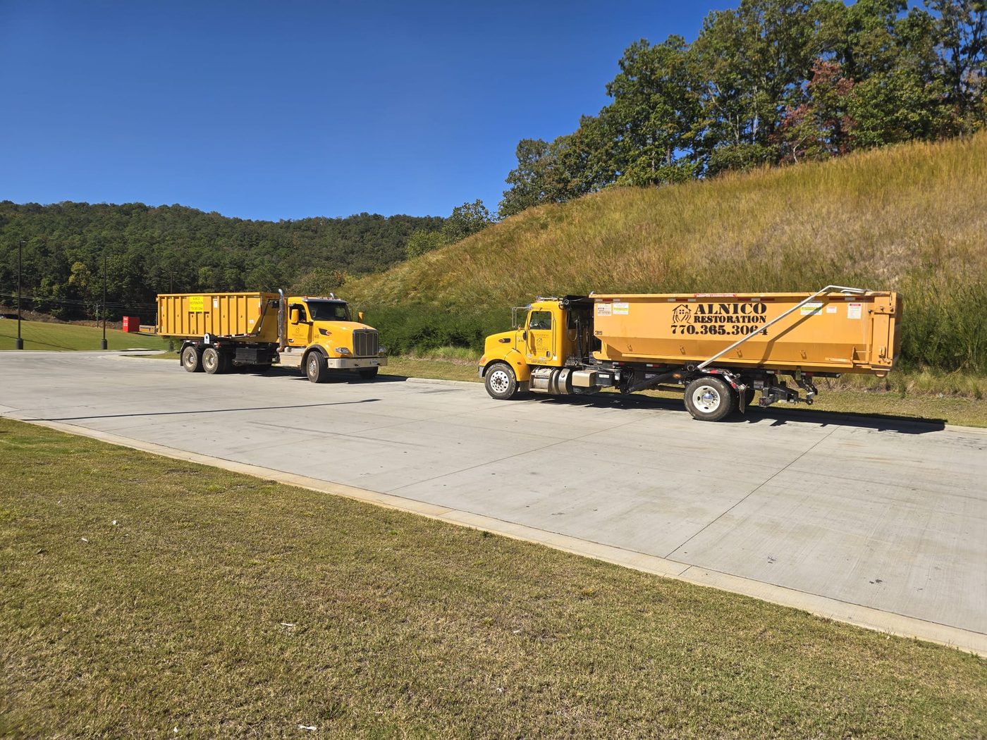 Two Alnico Peterbilt roll off trucks ready for service